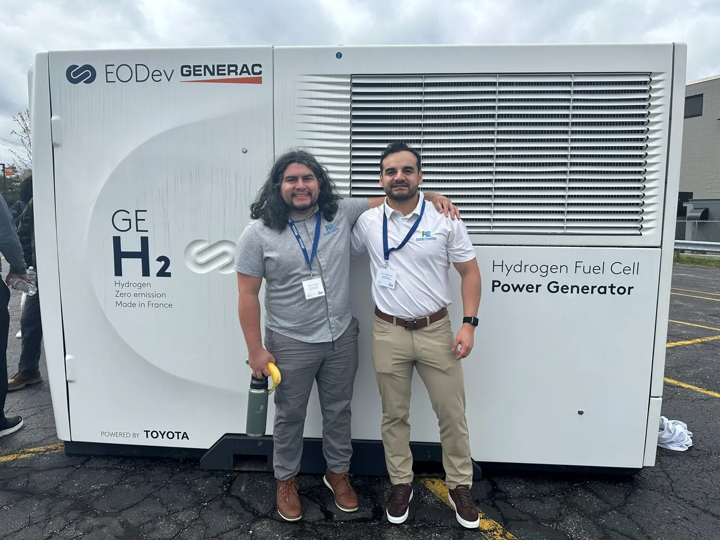 Progresíve engineers beside a hydrogen fuel-cell power generator